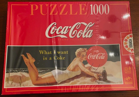25196-1 € 20,00 coca cola puzzel 1000 stukjes dame liggend op strand.jpeg